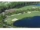 Aerial view of a scenic golf course with a lake at 19439 Beacon Park Pl, Bradenton, FL 34202