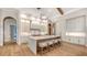 Modern kitchen with white cabinets, large island, and hardwood floors at 19439 Beacon Park Pl, Bradenton, FL 34202