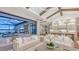 Living room with access to a covered patio, pool, and stunning sunset view at 19439 Beacon Park Pl, Bradenton, FL 34202