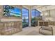Modern outdoor kitchen with stainless steel appliances and fireplace at 19439 Beacon Park Pl, Bradenton, FL 34202