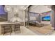 Modern outdoor kitchen with bar seating and views to the entertainment area at 19439 Beacon Park Pl, Bradenton, FL 34202