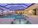 Luxury pool and spa with covered lanai and water features at 19439 Beacon Park Pl, Bradenton, FL 34202
