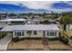 Aerial view of a yellow house and surrounding neighborhood at 2107 Palma Sola Blvd # 84, Bradenton, FL 34209