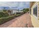 Brick paved patio area, lush landscaping, and a partially visible fence at 2107 Palma Sola Blvd # 84, Bradenton, FL 34209