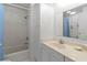 Well-lit bathroom featuring a shower-tub combo with tiled walls and a vanity at 2107 Palma Sola Blvd # 84, Bradenton, FL 34209