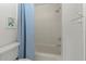 Clean bathroom showcasing a tiled shower/tub, toilet, and storage cabinet at 2107 Palma Sola Blvd # 84, Bradenton, FL 34209