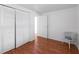 Bedroom featuring wood floors, closet, and a charming white chair at 2107 Palma Sola Blvd # 84, Bradenton, FL 34209