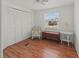 Bedroom featuring wood flooring, built-in storage, and a window at 2107 Palma Sola Blvd # 84, Bradenton, FL 34209