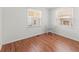 Second bedroom with hardwood floors and two windows at 2107 Palma Sola Blvd # 84, Bradenton, FL 34209
