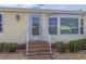 Close-up view of the front door and entry, complete with inviting walkway and landscaping at 2107 Palma Sola Blvd # 84, Bradenton, FL 34209