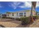 Exterior view of a charming home with well-maintained landscaping and inviting walkway at 2107 Palma Sola Blvd # 84, Bradenton, FL 34209