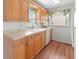 Well-lit kitchen featuring wood cabinets, laminate counters, and modern appliances at 2107 Palma Sola Blvd # 84, Bradenton, FL 34209