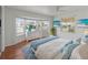 Inviting main bedroom with bright bay window, wood flooring, ceiling fan, and nautical color palette at 2107 Palma Sola Blvd # 84, Bradenton, FL 34209