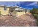 Brick patio wraps around this home offering outdoor living space, mature shrubs, and window awning detail at 2107 Palma Sola Blvd # 84, Bradenton, FL 34209