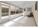 Enclosed sunroom with tile flooring, a ceiling fan, and a comfortable chair at 2107 Palma Sola Blvd # 84, Bradenton, FL 34209