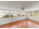 Bright sunroom with laminate wood flooring and multiple windows at 2107 Palma Sola Blvd # 84, Bradenton, FL 34209