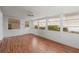 Spacious sunroom featuring wood-look flooring and a ceiling fan at 2107 Palma Sola Blvd # 84, Bradenton, FL 34209