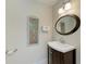 Cozy bathroom featuring a modern vanity, stylish light fixtures, and eye-catching artwork at 220 Monet Dr, Nokomis, FL 34275
