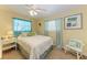 Cozy bedroom with bright decor, side table, and a comfortable bed at 220 Monet Dr, Nokomis, FL 34275