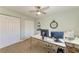 This bedroom is set up as a functional office with a neutral color palette and two closets at 220 Monet Dr, Nokomis, FL 34275