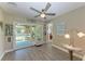 Sunroom area leading to outdoor screened space, featuring inviting decor and abundant natural light at 220 Monet Dr, Nokomis, FL 34275
