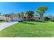 Charming home with a well-manicured lawn and tropical landscaping at 220 Monet Dr, Nokomis, FL 34275