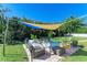 Relaxing patio area with shade sail and comfortable seating at 220 Monet Dr, Nokomis, FL 34275