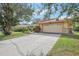 House exterior showcasing a two-car garage and a well-maintained lawn at 23302 Lucerne Pl, Land O Lakes, FL 34639