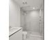 Modern bathroom with a large glass shower and white vanity at 301 Quay Commons # 1111, Sarasota, FL 34236