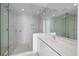 Modern bathroom with glass shower and white vanity at 301 Quay Commons # 1111, Sarasota, FL 34236