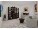 Spacious home office featuring built-in shelving and comfortable seating at 301 Quay Commons # 1111, Sarasota, FL 34236