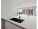 Modern kitchen with a sink, white countertop and city views at 301 Quay Commons # 1111, Sarasota, FL 34236