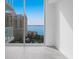 Bright living room with stunning water views and floor-to-ceiling windows at 301 Quay Commons # 1111, Sarasota, FL 34236