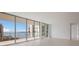 Modern living room with floor-to-ceiling windows and water views at 301 Quay Commons # 1111, Sarasota, FL 34236