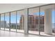 Spacious living room with floor-to-ceiling windows offering stunning water views at 301 Quay Commons # 1111, Sarasota, FL 34236
