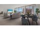 Open concept living and dining area with modern furnishings and water views at 301 Quay Commons # 1111, Sarasota, FL 34236