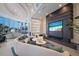 Modern lobby with large TV, comfortable seating, and a fireplace at 301 Quay Commons # 1111, Sarasota, FL 34236