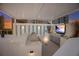 Modern outdoor kitchen with grills and a stunning sunset view at 301 Quay Commons # 1111, Sarasota, FL 34236