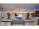 Modern outdoor kitchen with grills, a large TV, and a covered area at 301 Quay Commons # 1111, Sarasota, FL 34236