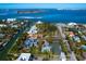 Stunning aerial view of a waterfront property with a private tennis court at 3460 Flamingo Ave, Sarasota, FL 34242