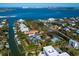 An aerial view of the property, waterfront with dock and tennis court at 3460 Flamingo Ave, Sarasota, FL 34242