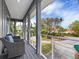 Relaxing balcony with seating, overlooking a landscaped area and paver driveway at 3460 Flamingo Ave, Sarasota, FL 34242