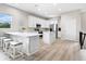 Modern kitchen with white cabinets, stainless steel appliances, and an island with seating at 3460 Flamingo Ave, Sarasota, FL 34242