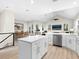 Open kitchen with white cabinets, stainless steel appliances, and an island at 3460 Flamingo Ave, Sarasota, FL 34242