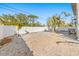 Large backyard with white vinyl fence and gravel ground cover at 3511 Camino Real, Sarasota, FL 34239