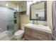 Modern bathroom with walk-in shower and wood vanity at 3511 Camino Real, Sarasota, FL 34239