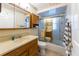 Clean bathroom with shower/tub combo, vanity, and mirrored medicine cabinet at 3511 Camino Real, Sarasota, FL 34239