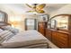 Main bedroom with a king-size bed, dresser, and large mirror at 3511 Camino Real, Sarasota, FL 34239