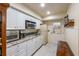 White kitchen cabinets, granite countertops and door to outside at 3511 Camino Real, Sarasota, FL 34239