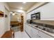 Modern kitchen with granite countertops and stainless steel appliances at 3511 Camino Real, Sarasota, FL 34239
